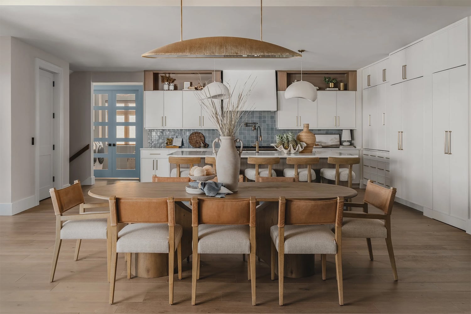 Coastal kitchen decor with organic textures, woven baskets and white cabinets.