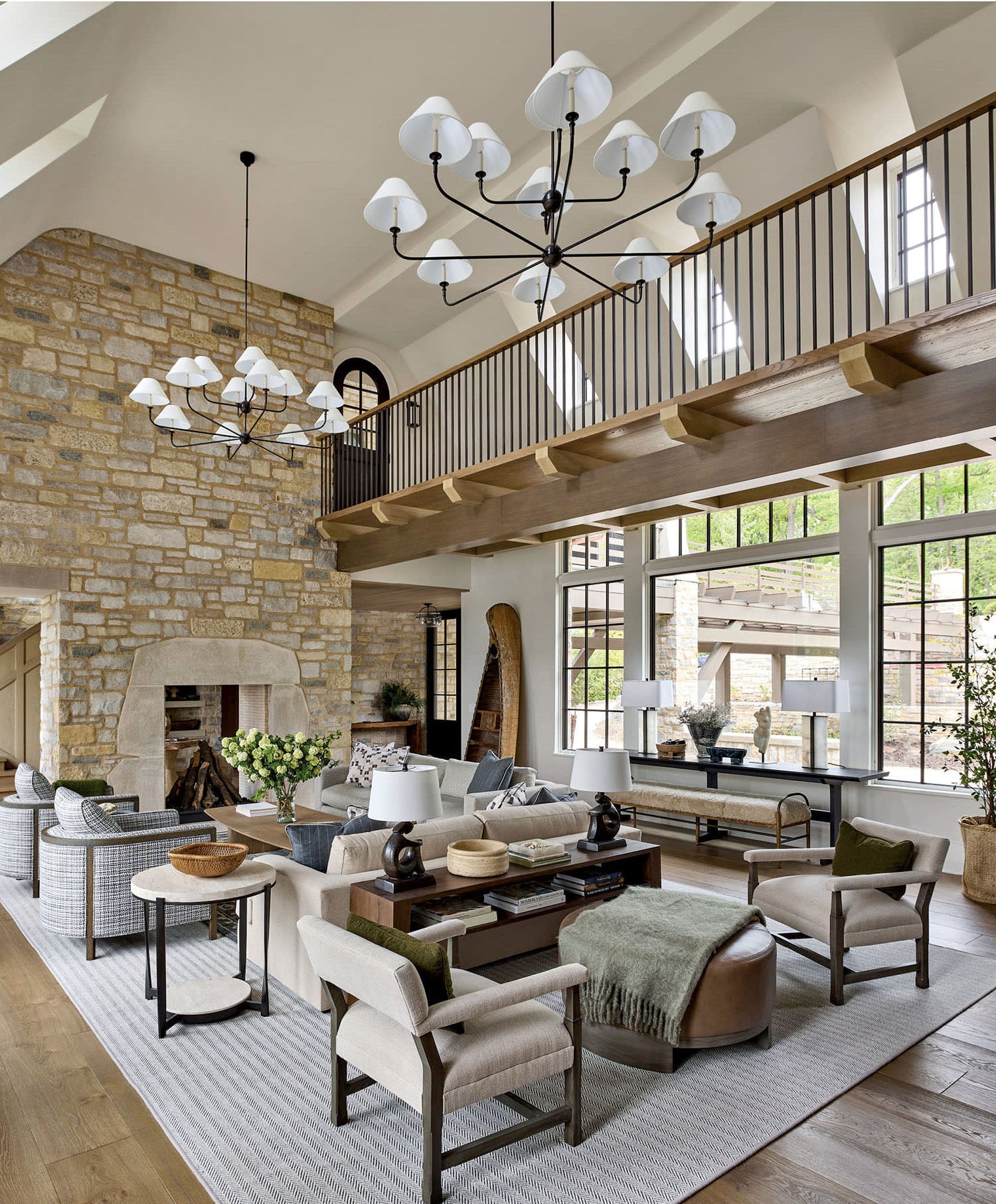 Coastal living room with stone fireplace, light oak flooring and modern furniture.