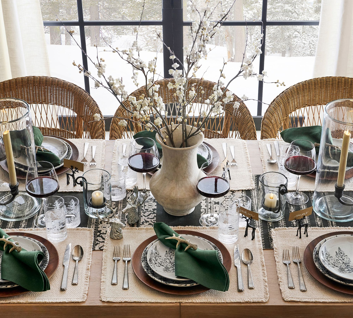A Thanksgiving tablescape with green linen napkins and antler napkin rings