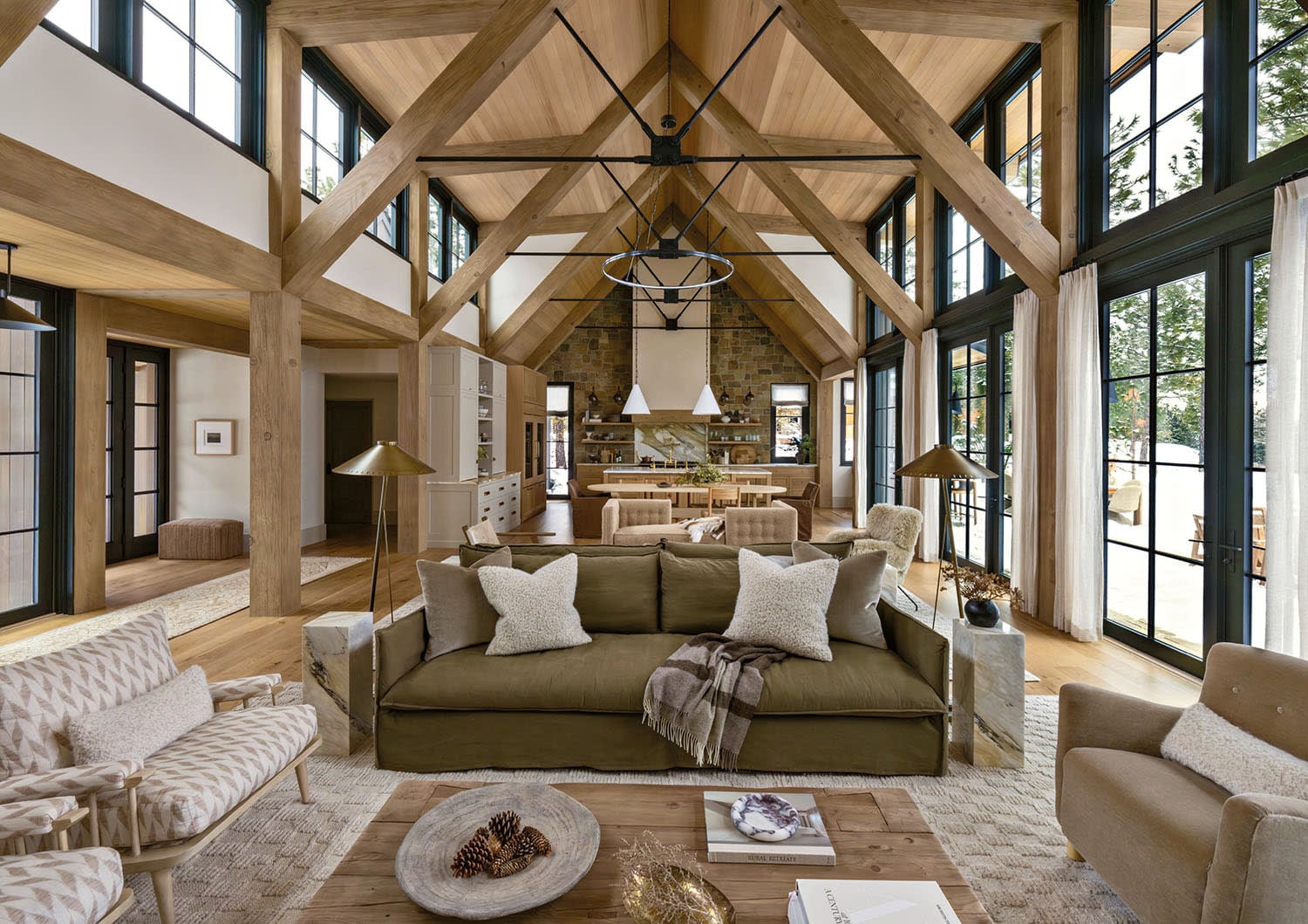 Modern rustic living room with light wood flooring, and olive green sofa.