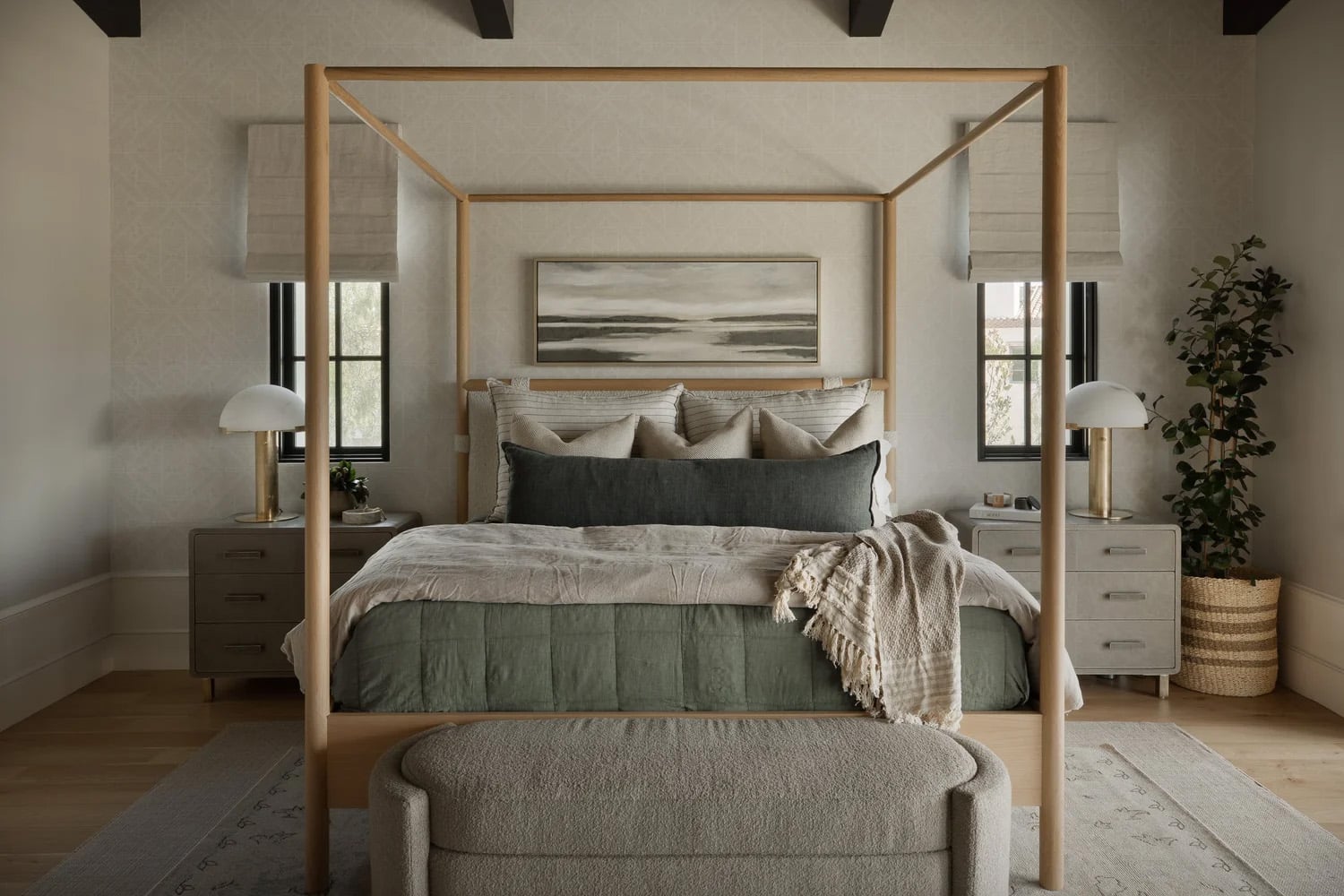 Farmhouse bedroom with light oak canopy bed, linen bedding and dark wood ceiling beams