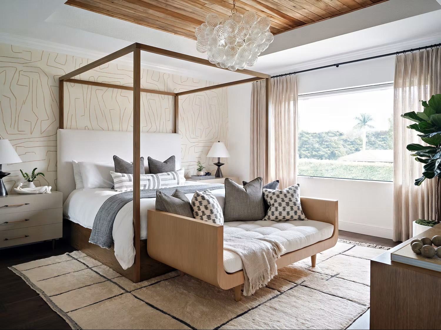 Farmhouse bedroom with white-and-gray linen bedding and dark wood flooring