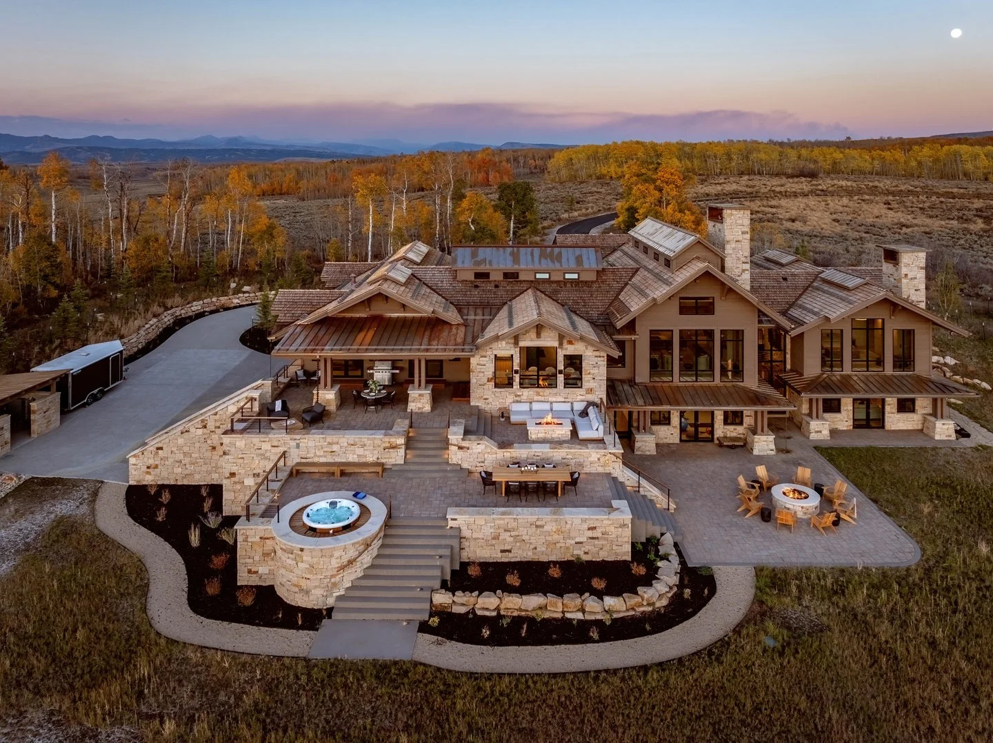 Rustic home exterior with distinct outdoor entertaining zones