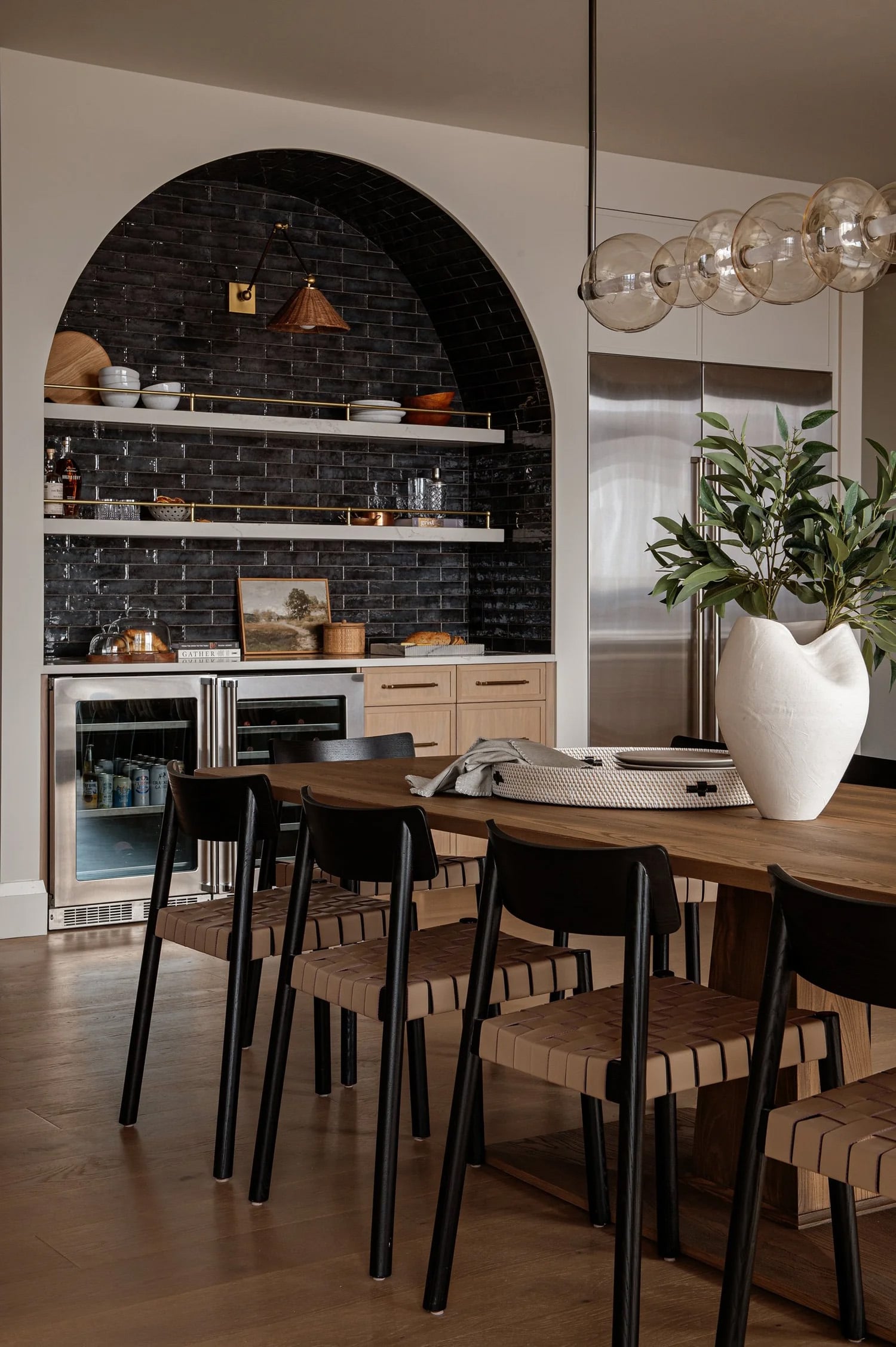 Open shelving built into an archway with brass railing