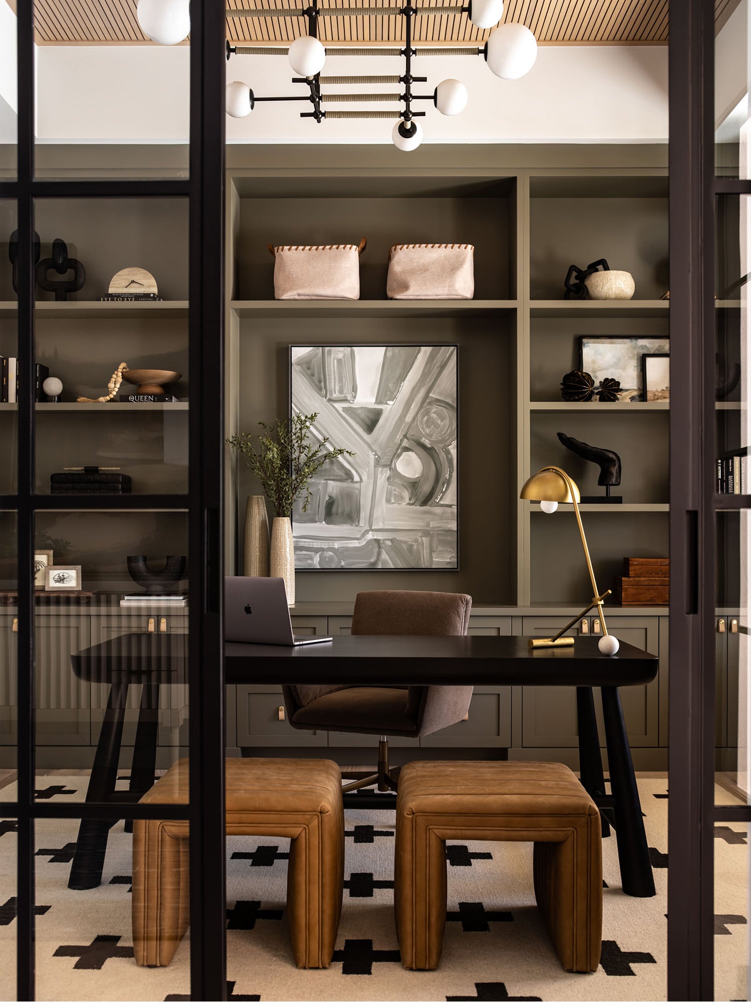 Modern home office with olive green open shelving