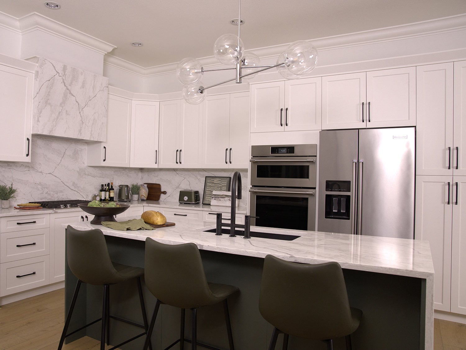 After photo of a kitchen renovation by Tracy Svendsen with white cabinets.