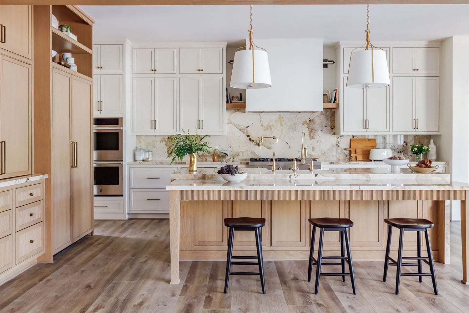 Modern kitchen with combined light oak and white cabinets with dramatic backsplash.