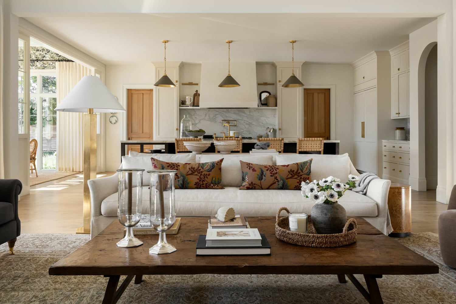 Open-concept kitchen with white cabinets, Benjamin Moore Swiss Coffee.