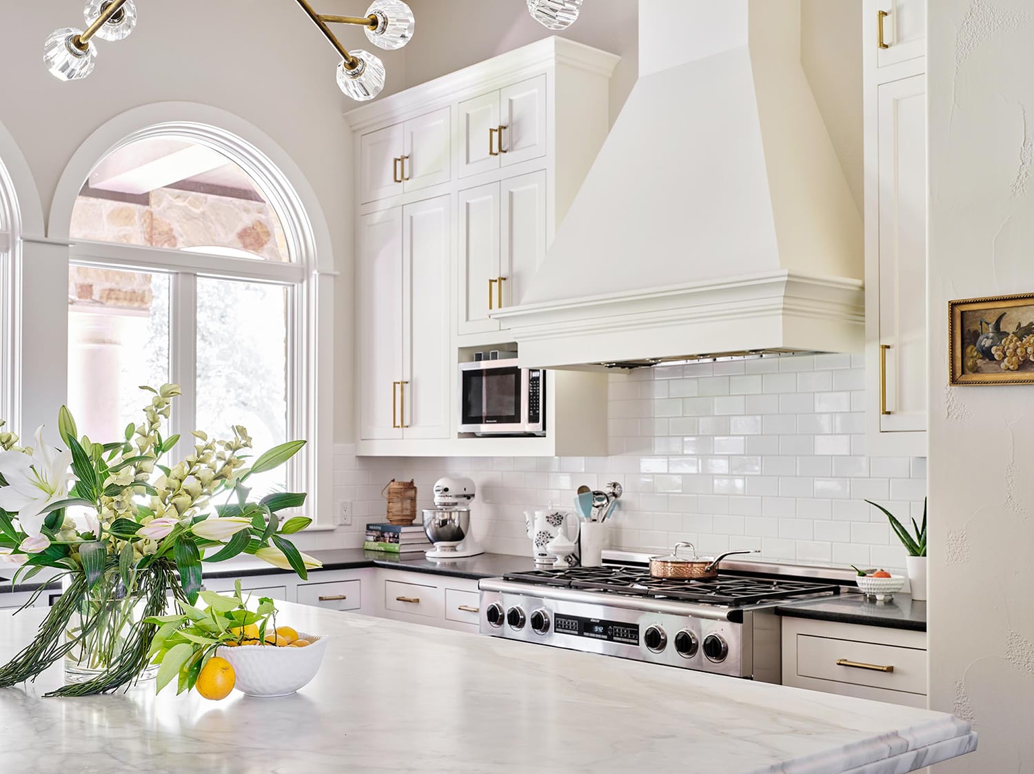 Traditional kitchen with white cabinets, backsplash and island, Sherwin Williams Greek Villa.