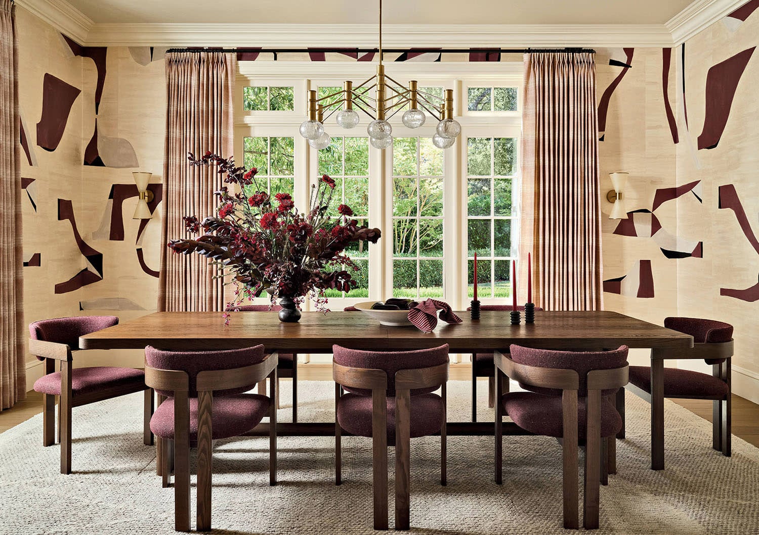 Modern farmhouse dining room with contemporary wallpaper and velvet chairs.