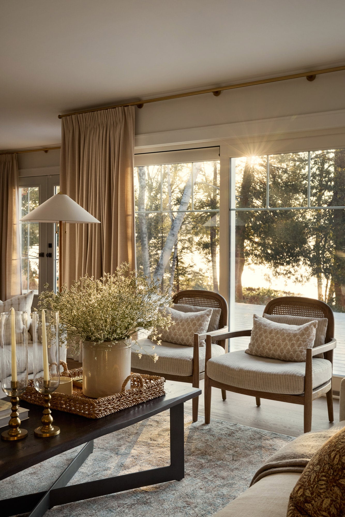 Modern farmhouse living room with layered textures and golden natural sunlight.