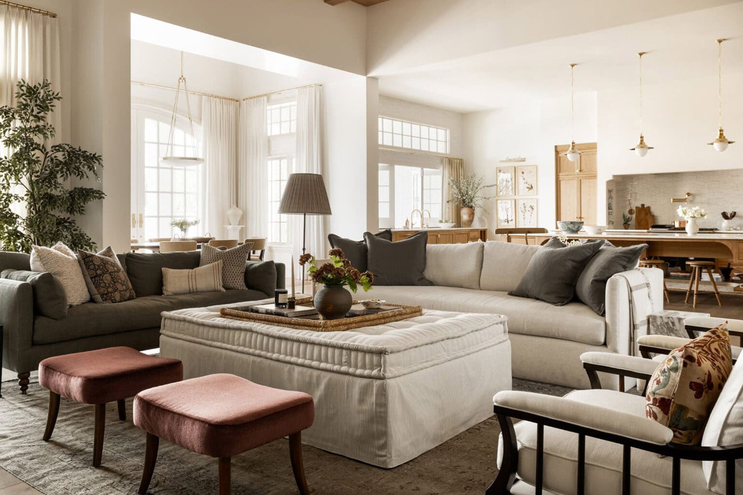 Modern farmhouse living room with white linen sofa, light wood flooring, and white walls.