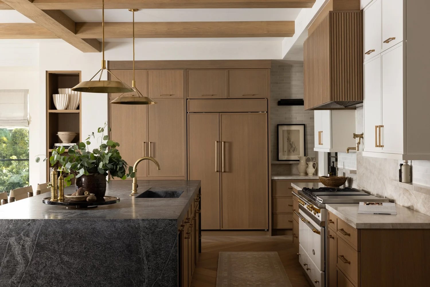 Two-tone light wood and white kitchen cabinets with gray stone island.