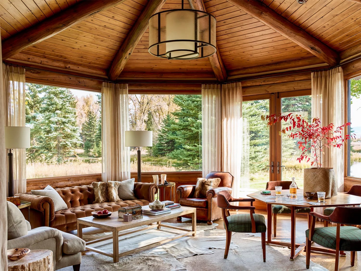 Handcrafted log home with vaulted wood ceiling, wood flooring, and leather furniture