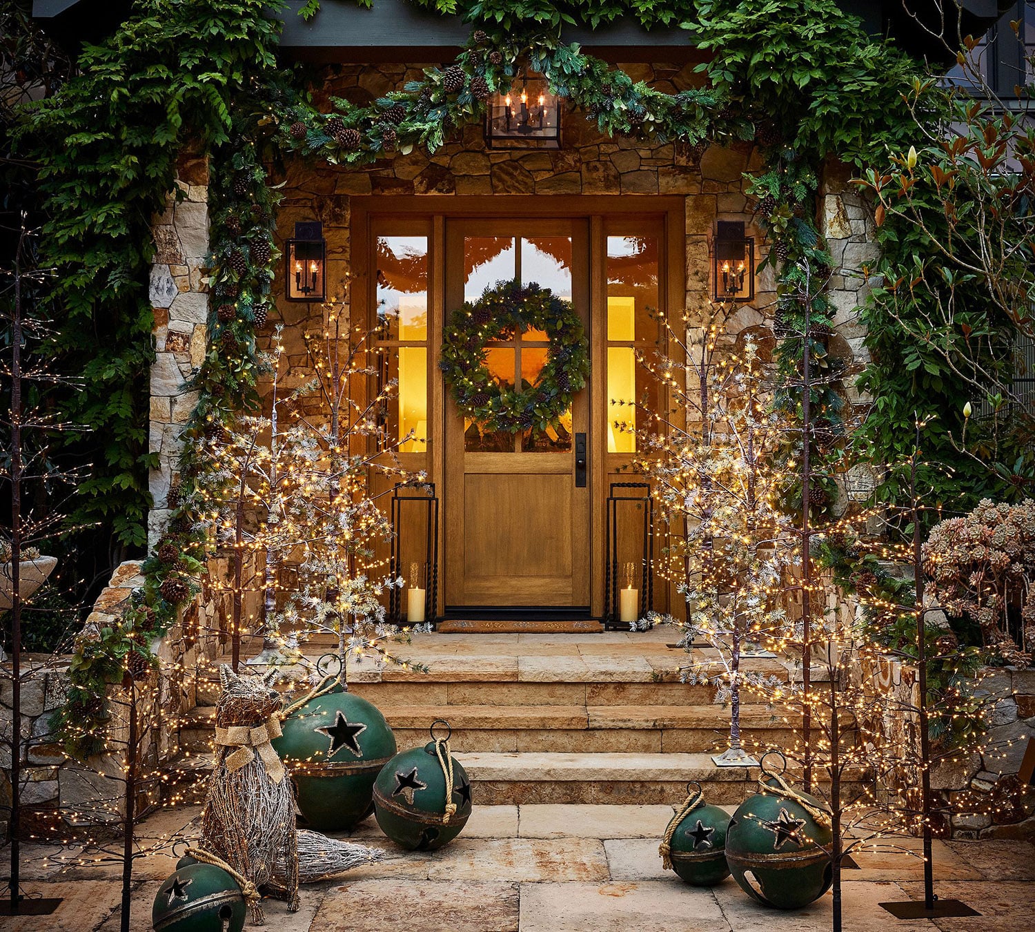 Christmas front porch with garland and twinkle branch trees