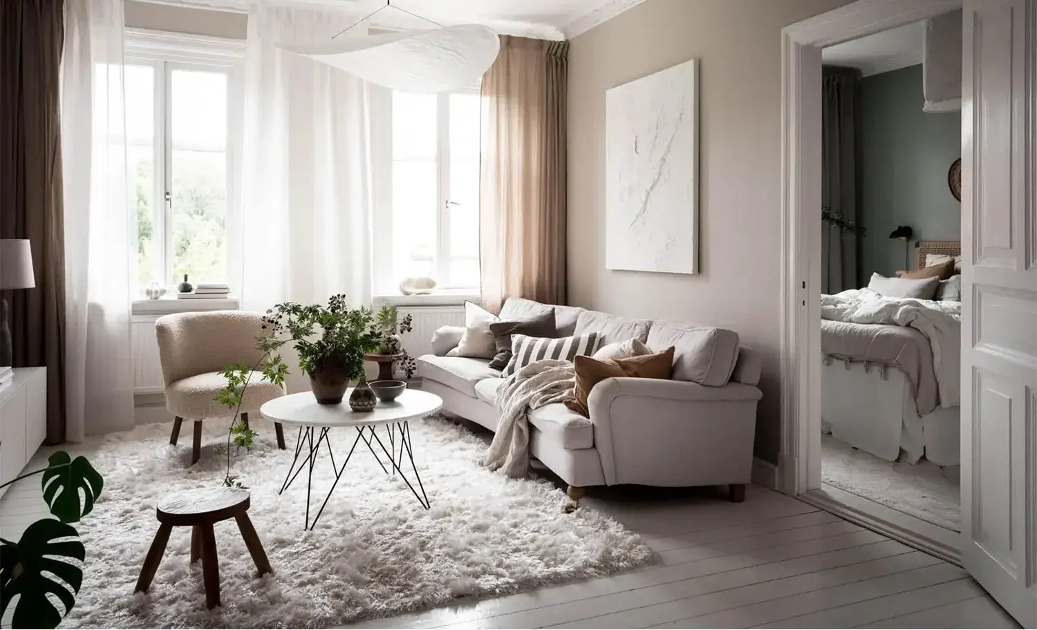 Scandinavian living room with white-washed wood flooring, a flokati-style rug and white walls