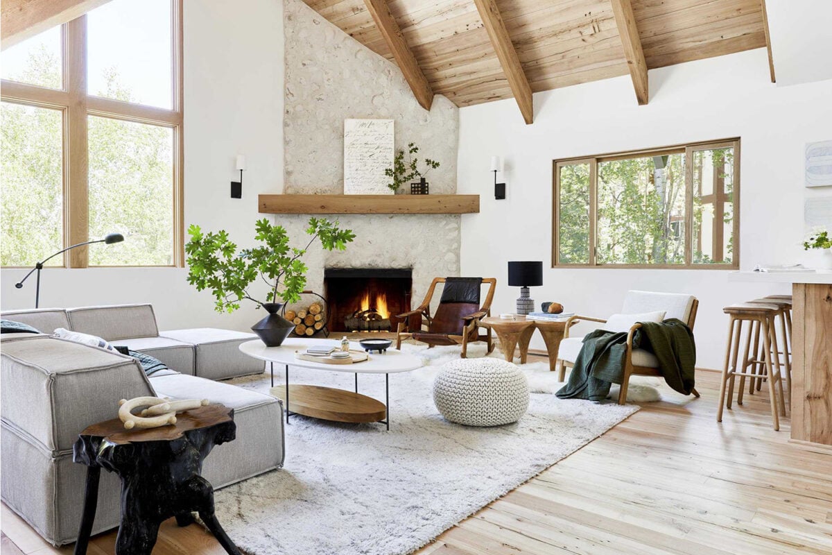 Rustic Scandinavian living room with white walls, light wood ceiling and flooring and layered textures