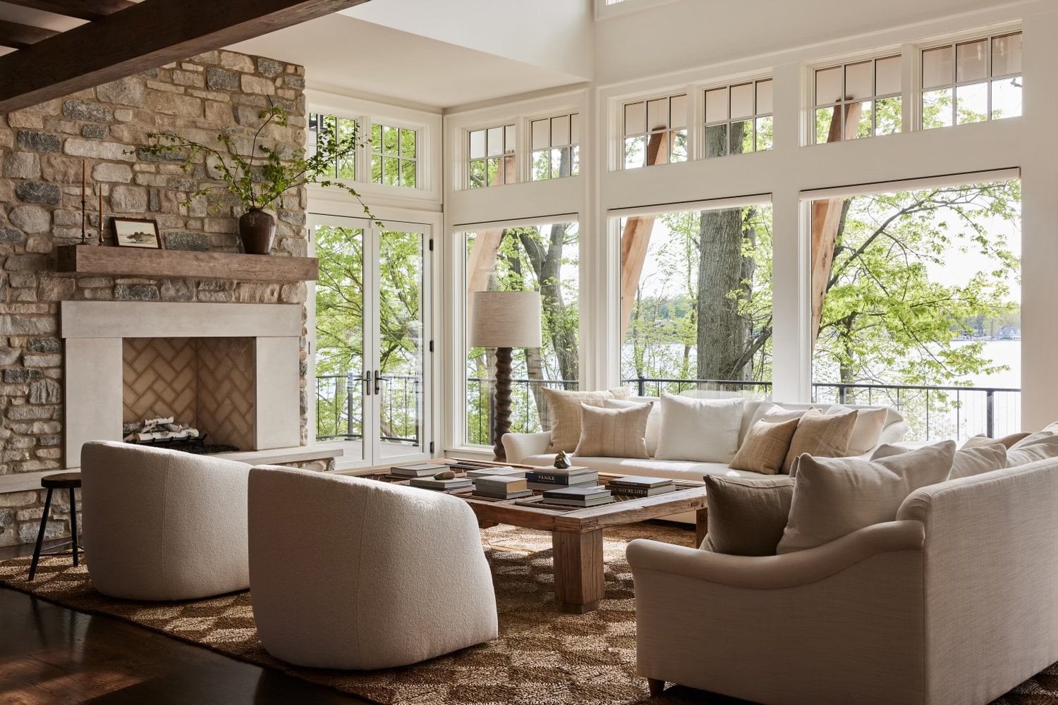 Coastal living room with warm wood flooring, and a color scheme of browns, creams and whites. 
