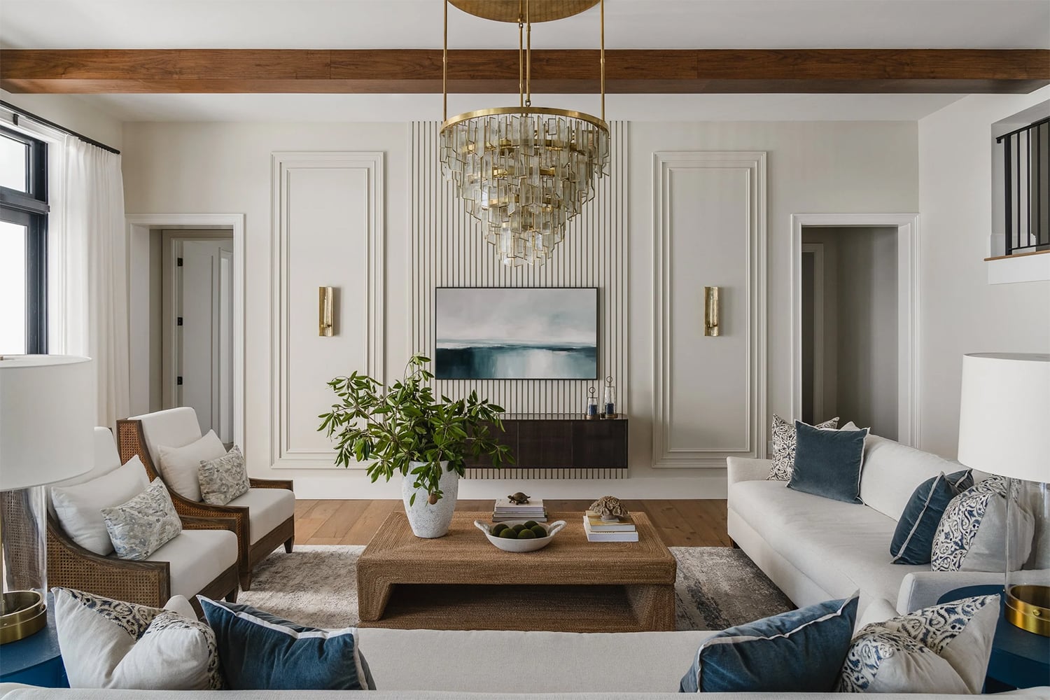 Luxury coastal living room with contemporary accents and a crystal chandelier.