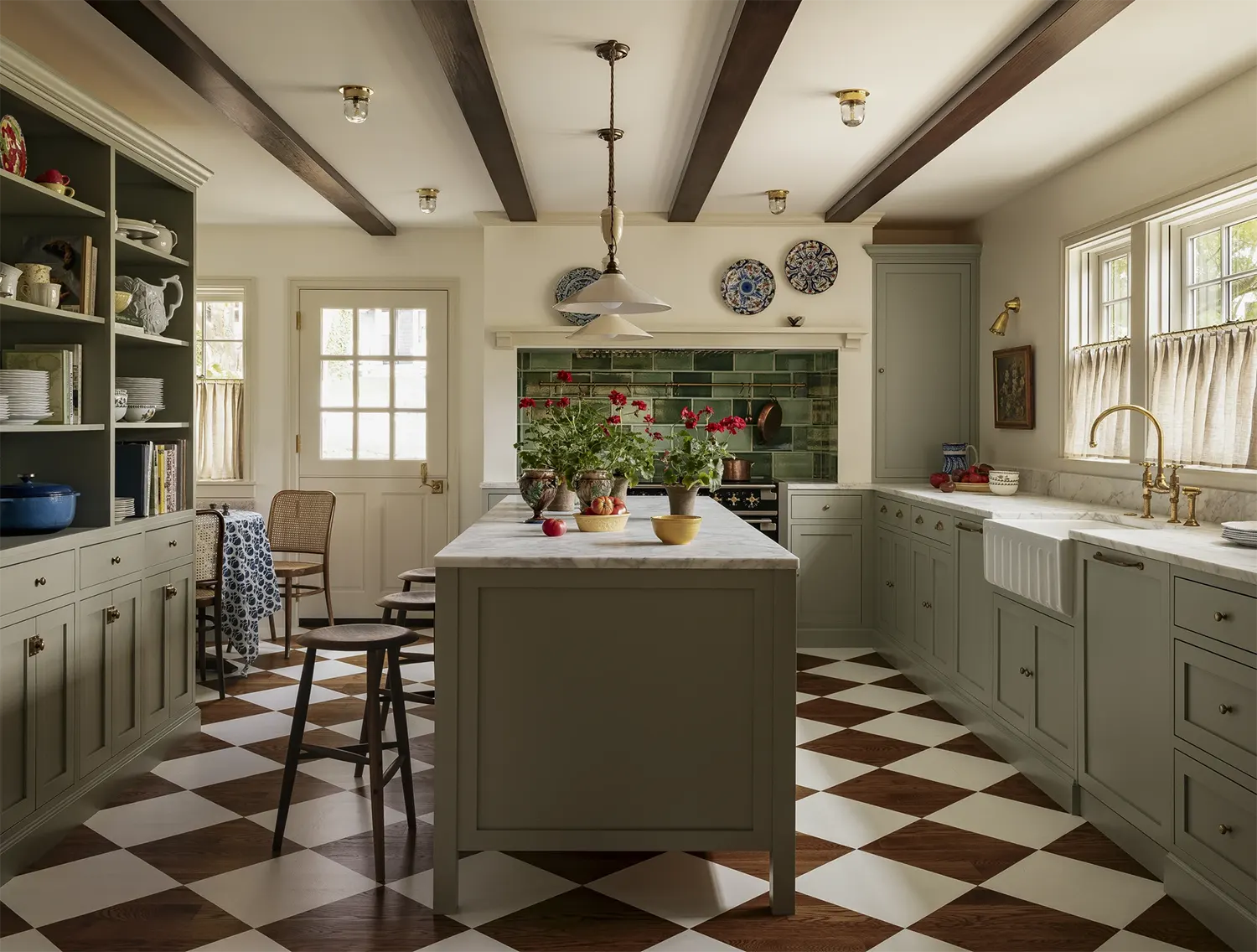 Country kitchen with sage green lower cabinets and green backsplash 