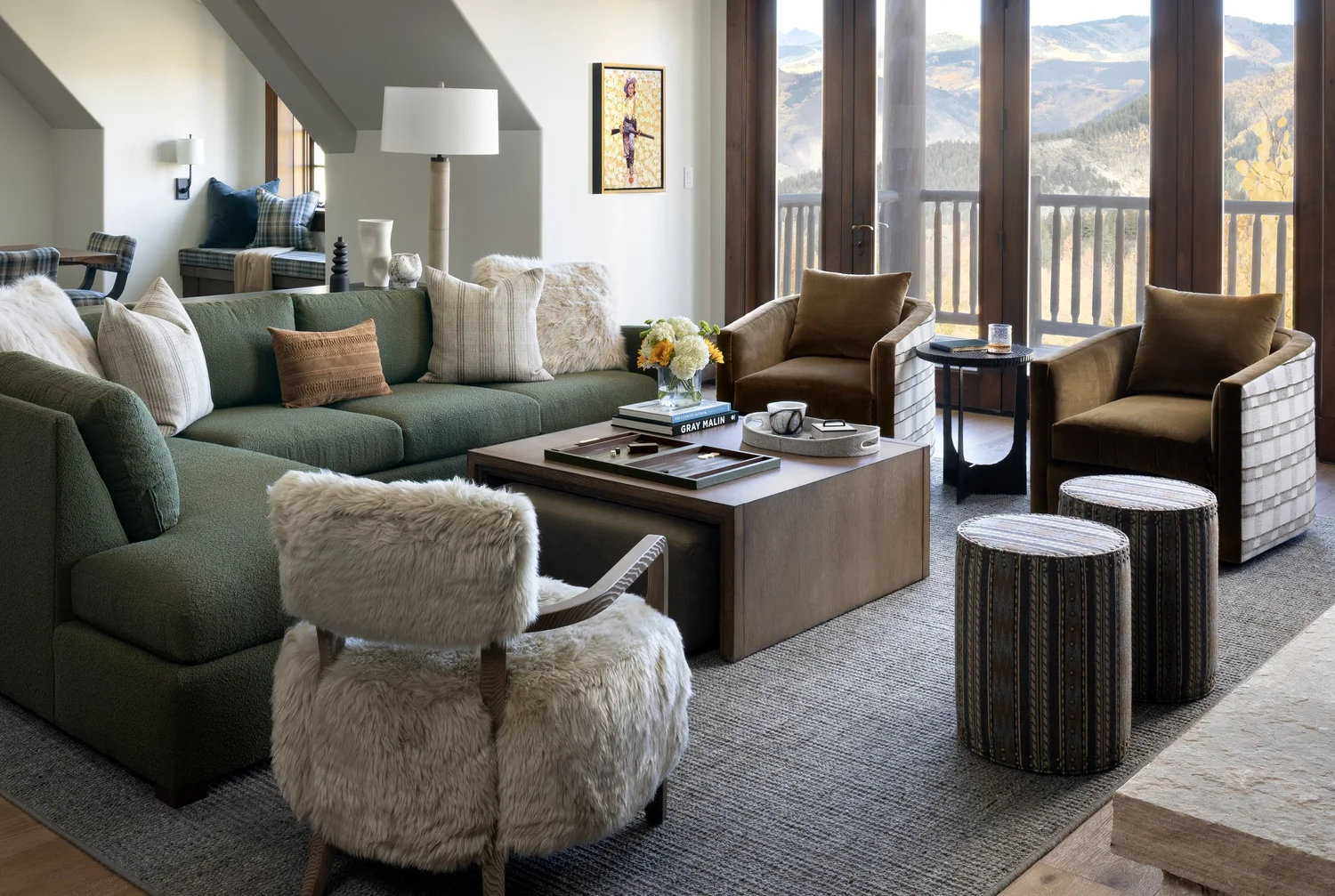 Modern mountain living room with a sage green sectional and white walls