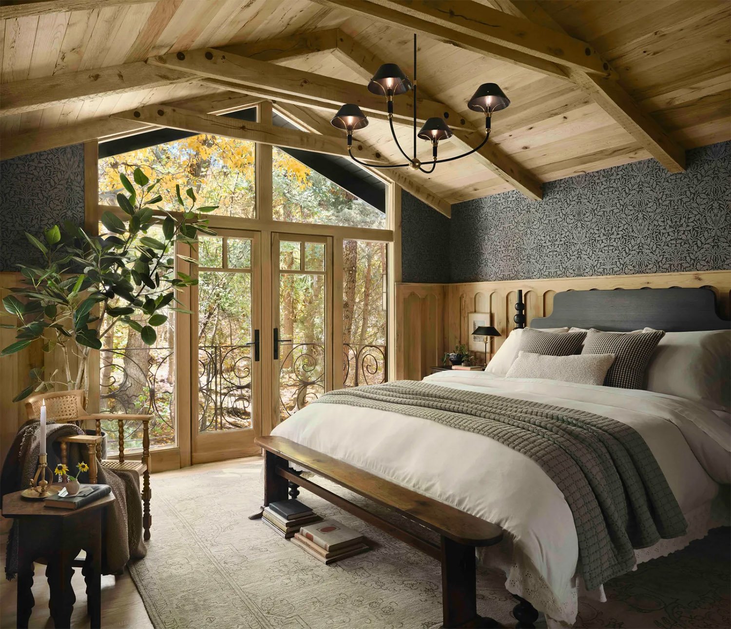 Chip & Joanna Gaines Colorado primary bedroom with wood vaulted ceiling, layered neutrals and botanical wallpaper.