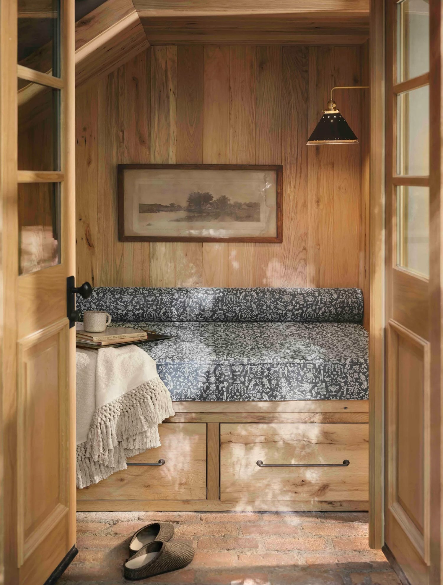 Cozy reading nook in the Gaine's Colorado home with light wood paneling.