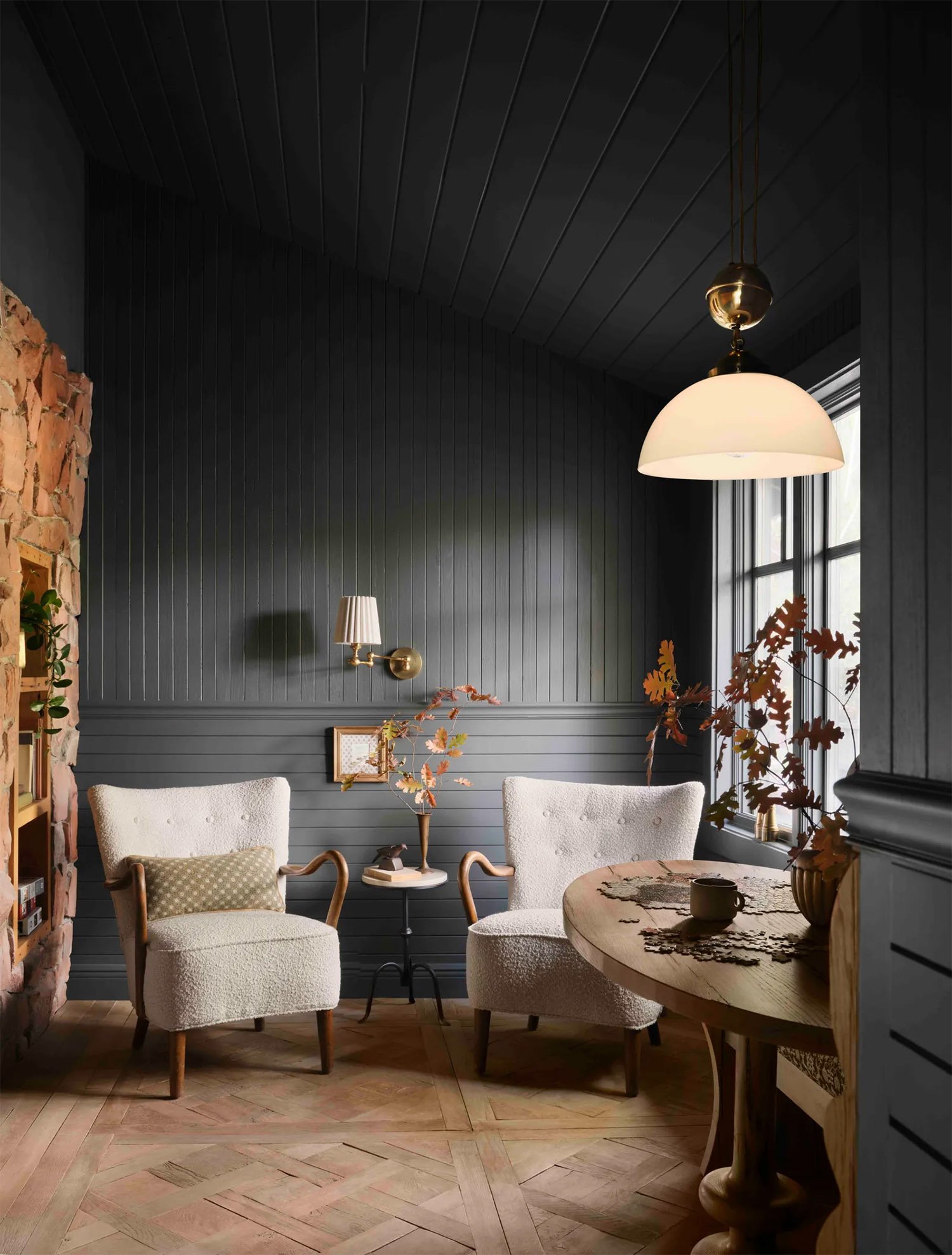 Reading space in the Gaine's home with dark gray walls and light wood flooring.