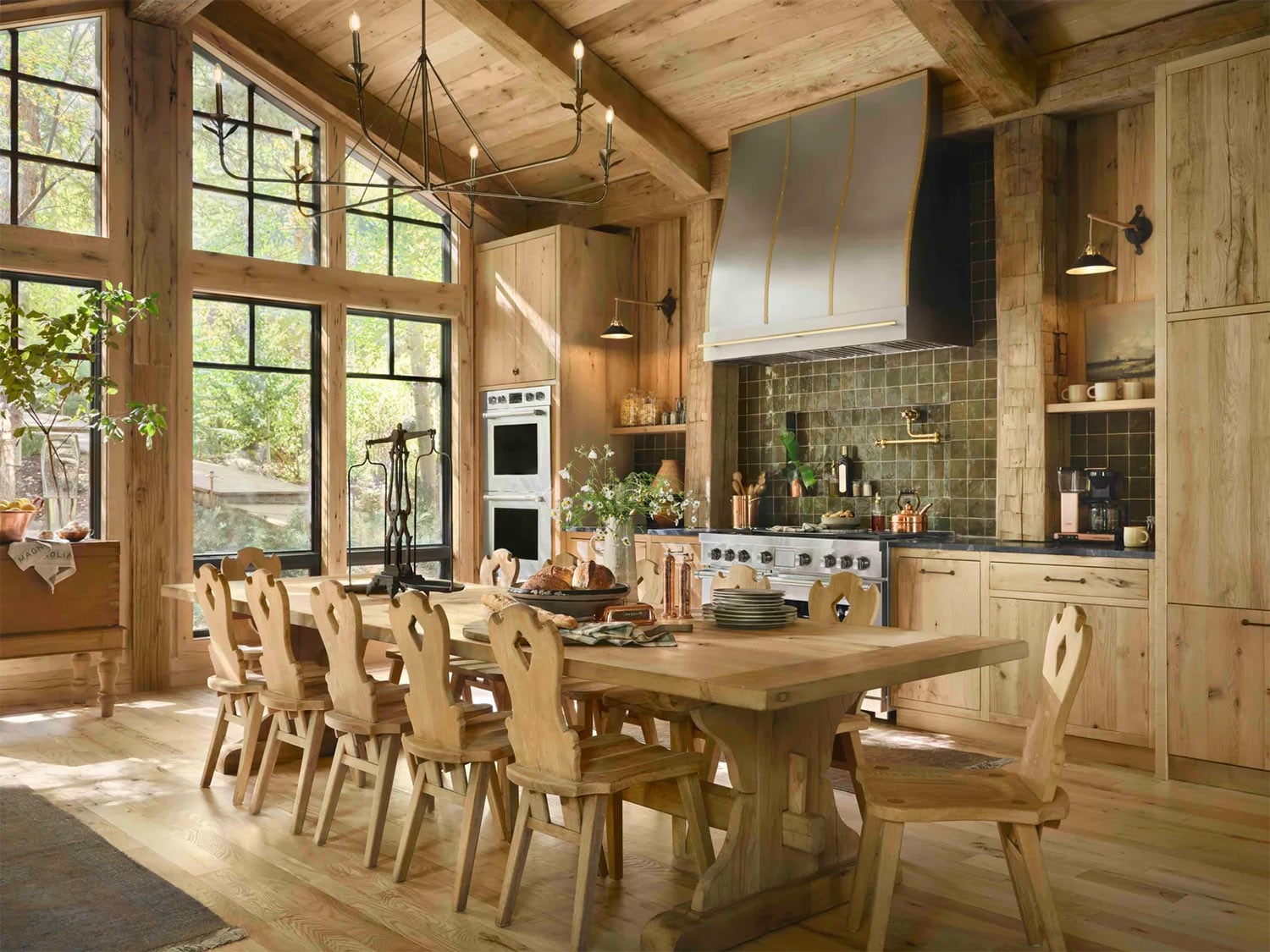 Chip and Joanna Gaine's kitchen with vaulted ceiling, light wood cabinets and iron hardware.