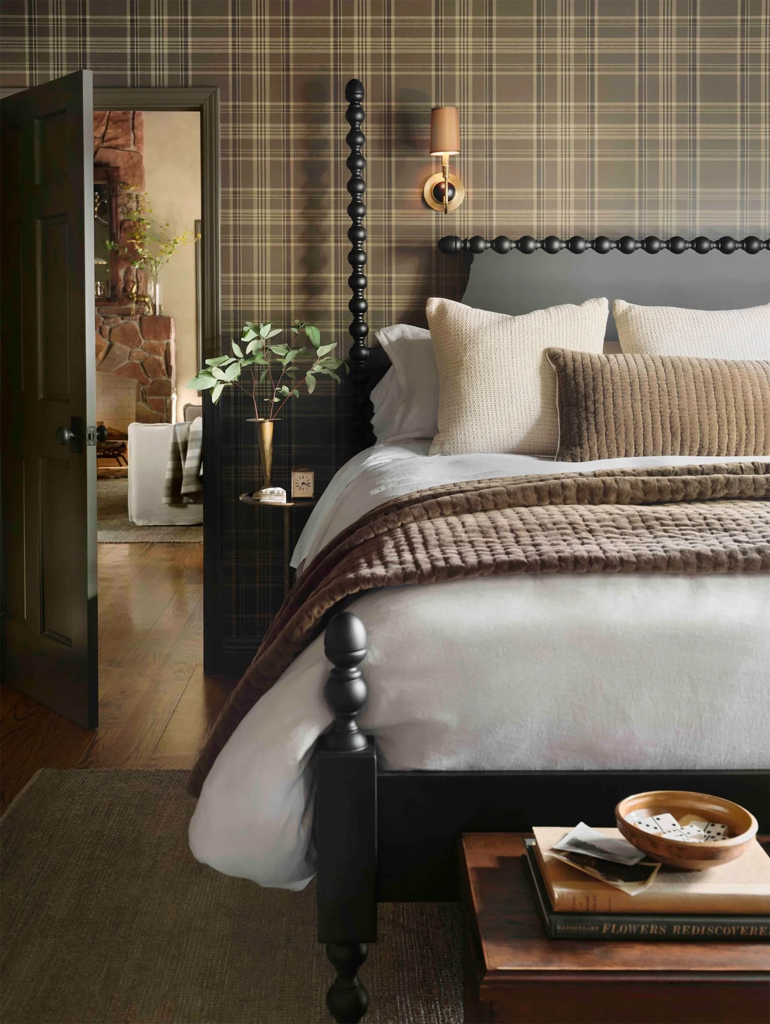 Country cottage guest bedroom with saturated earth tones, plaid wallpaper and cozy bedding.